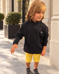 Heritage Navy Junior Hoodie — boy from the front, embroidered Moon XIII monogram on the chest