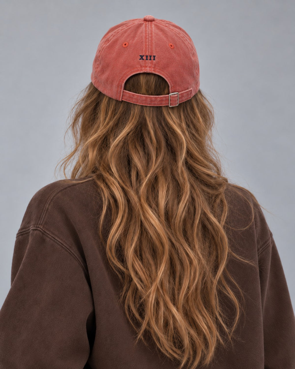 Hamptons Coral Cap — model from behind, embroidered XIII numeral and buckle