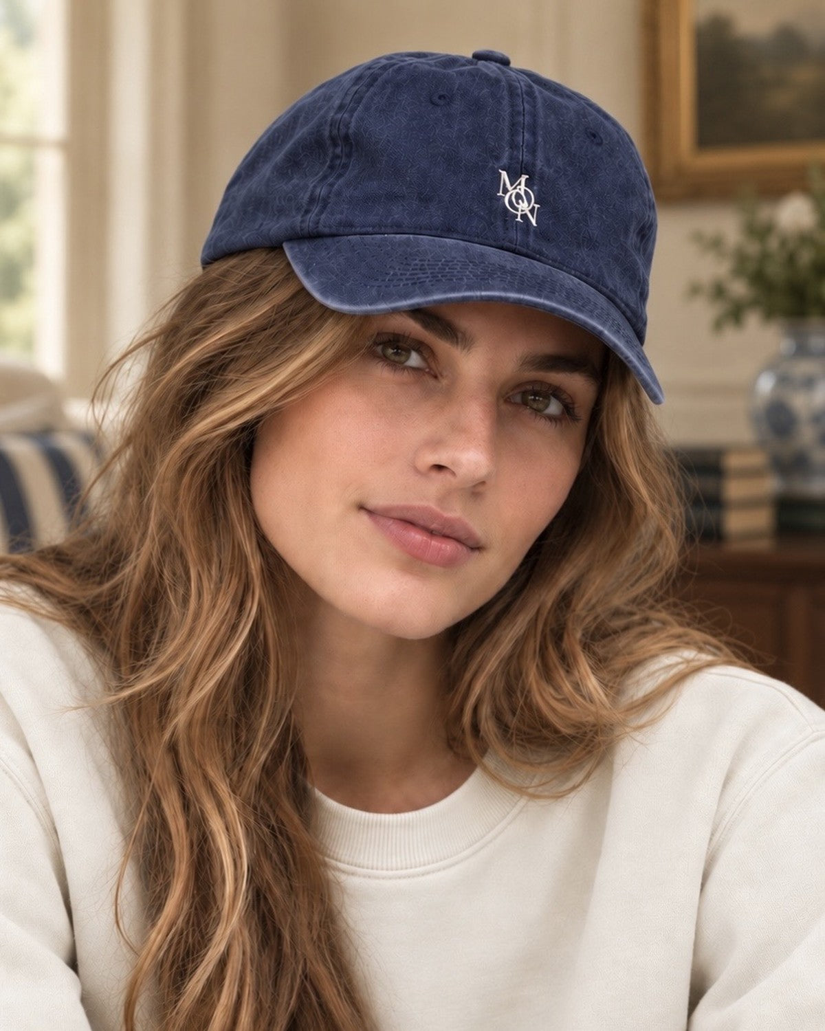 Hamptons Navy Cap — model from the front in a living room